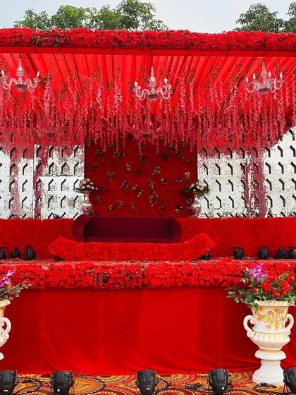 A frontal view of another all-red stage design, this one featuring a silver patterned backdrop for a modern touch.