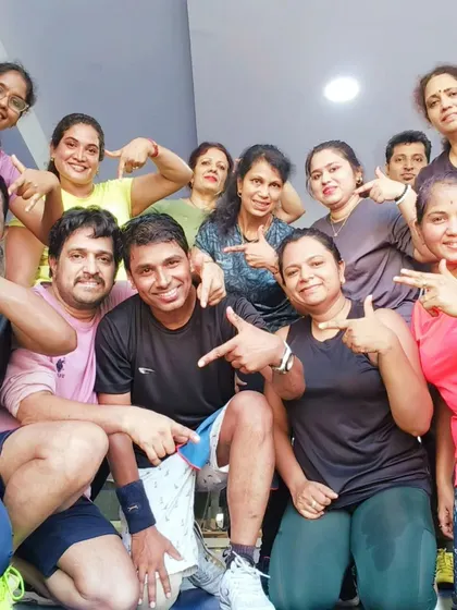 Everyone pointing to the center of our community, our instructor. We are a team working together towards our fitness goals.
