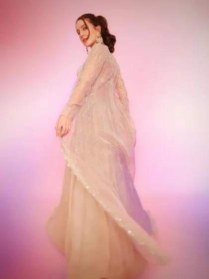A back view that captures the beautiful drape of the sheer jacket. This outfit is all about soft, romantic glamour.