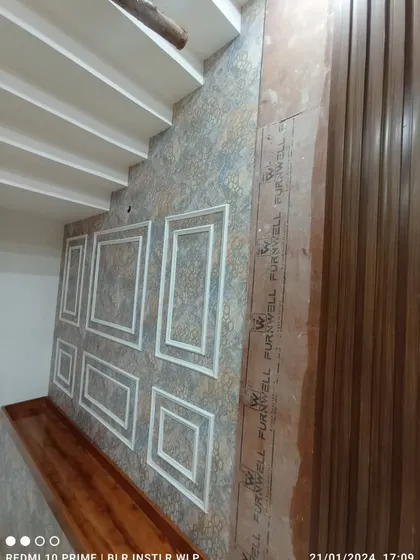 The staircase wallpaper installation in progress.