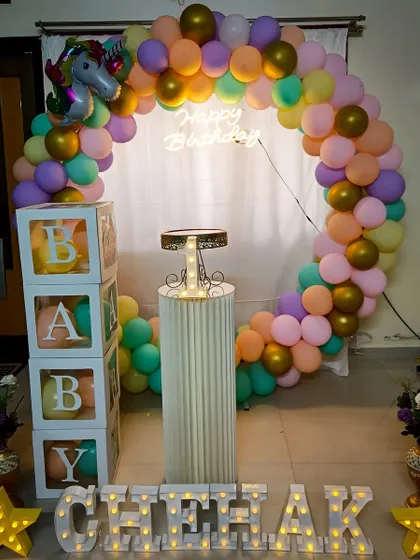 A simple yet magical unicorn-themed birthday setup. The pastel balloon ring and 'BABY' blocks are perfect for a sweet and charming celebration.