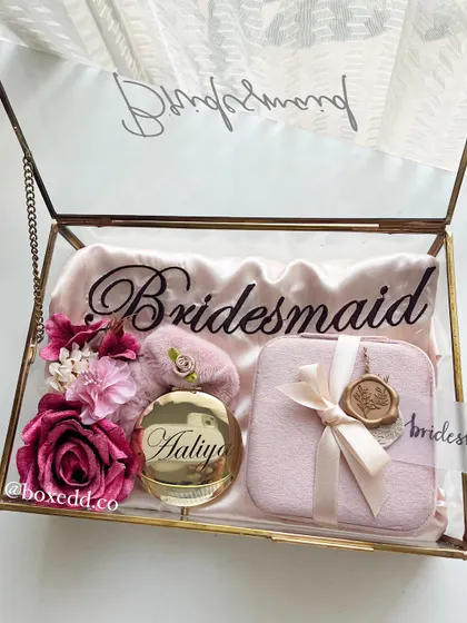 The complete bridesmaid proposal gift, beautifully displayed in a glass and brass box. This view shows how all the elements, from the robe to the floral decor, come together to create a stunning presentation.