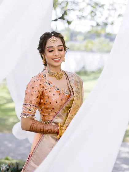 A serene and beautiful portrait of the bride. Her eyes are closed, showing off the soft, blended eyeshadow that enhances her natural beauty.