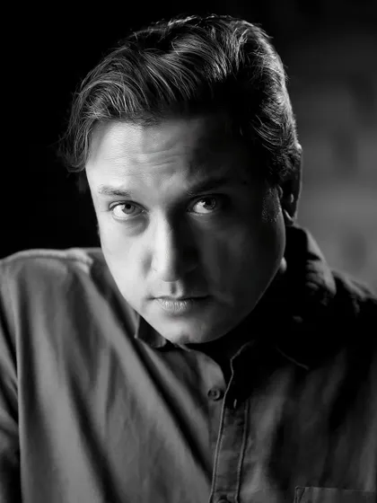 An intense, dramatic black and white portrait of Sanjev Sharma. The close crop and direct gaze make this a very powerful headshot.
