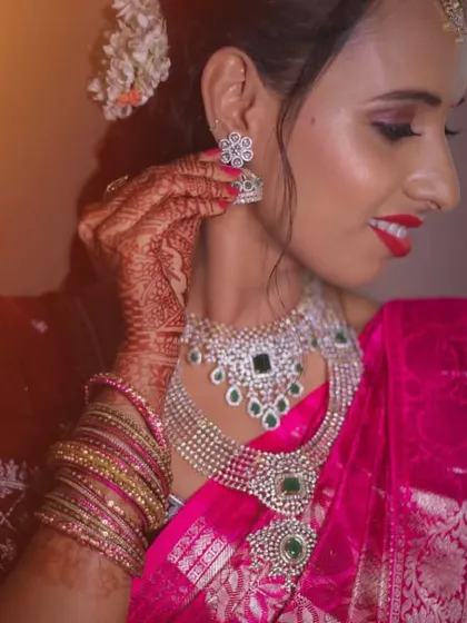 A client adjusting her earring, giving a glimpse of the complete, sparkling reception jewellery set.