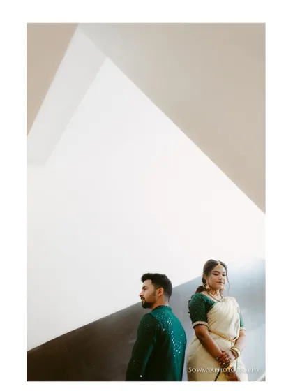 A minimalist and modern couple portrait. The clean architectural lines and negative space draw all the attention to the couple's quiet connection.