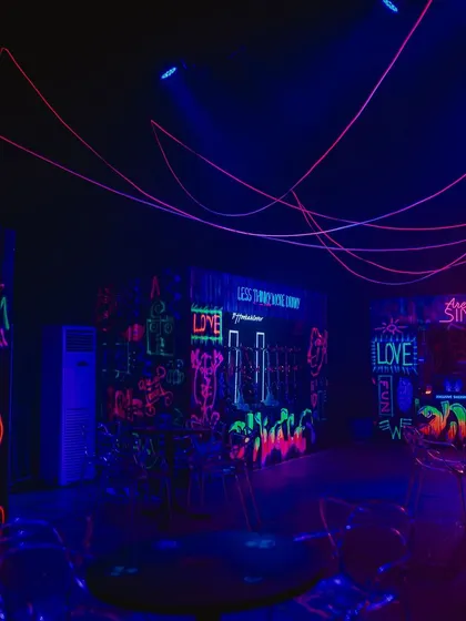 We created a 'graffiti zone' where walls were covered in glowing UV paint art and playful phrases. This interactive area added to the fun, rebellious spirit of the party.