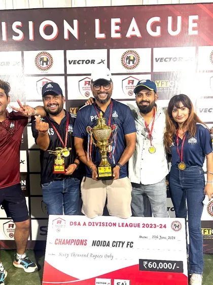 The leadership team celebrating with the championship trophy. Our success is a collective effort from everyone involved in the club.