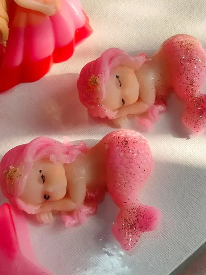 Adorable sleeping mermaid baby soaps with glittery tails. These are perfect for a mermaid or under-the-sea themed party.