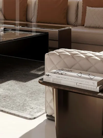 A close-up of the quilted sofa and bespoke side table. Every detail, from the stitching to the curated books, is chosen to create a sense of elegant and intentional living.