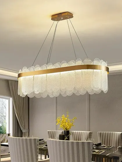 This elegant rectangular chandelier features scalloped glass pieces that create a soft, textured light. It's an ideal choice for hanging over a formal dining table.