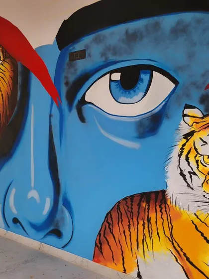 We created this powerful mural for Nueva Cafe, featuring a close-up of a blue-skinned face with intense eyes, flanked by two realistic tigers.