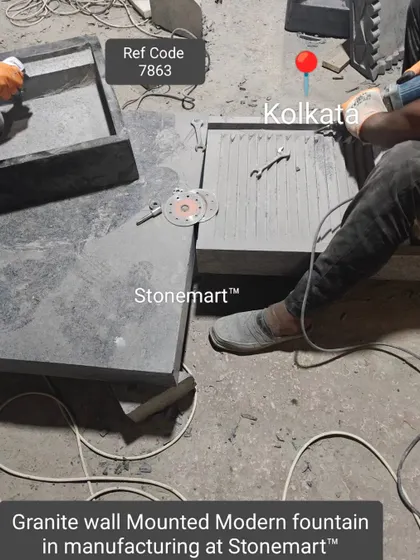 The components of a granite wall-mounted modern fountain are laid out during the manufacturing process.