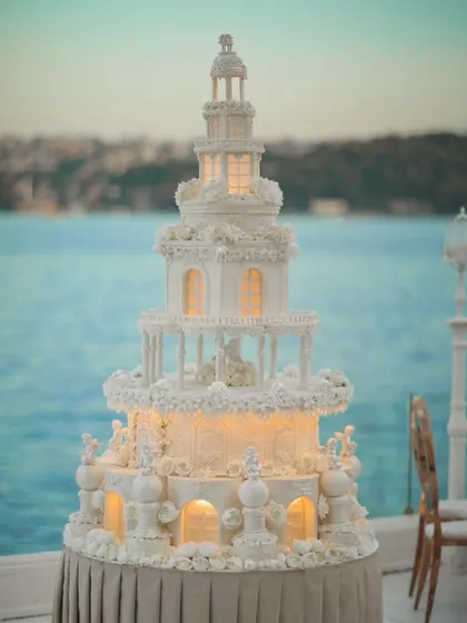 From grand decor to the smallest details, we ensure every element is perfect. This magnificent, multi-tiered wedding cake, illuminated from within, served as a stunning centerpiece for a seaside reception.