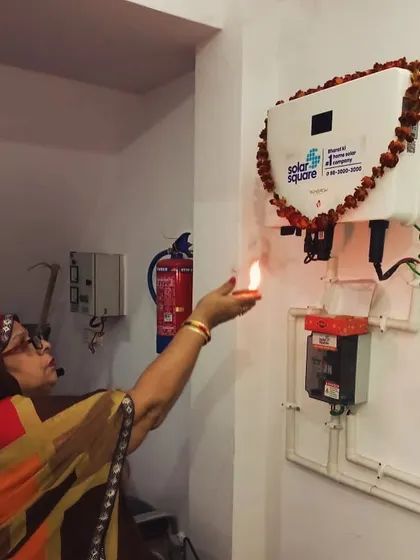 A customer performs an aarti for her new solar inverter, marking an auspicious start to her clean energy journey.