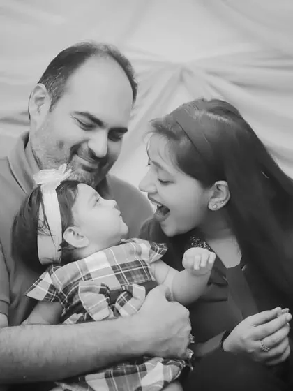 The same playful moment as before, rendered in timeless black and white to emphasize the expressions and emotion.