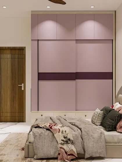 The sliding wardrobe is finished in a beautiful lavender shade with a contrasting maroon stripe, tying the room's color scheme together.