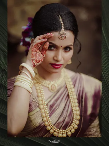 A powerful and confident pose from the bride, her traditional attire and bold expression making for a striking portrait.