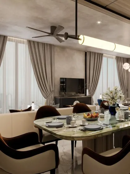 A close-up of the dining table setting, showing the elegant green marble top and two-toned chairs. The design focuses on creating a sophisticated and inviting atmosphere for shared meals.
