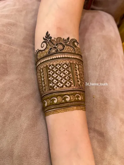 A completed cuff design with intricate 'jaal' work and a floral border. This is a classic and elegant choice for any celebration.