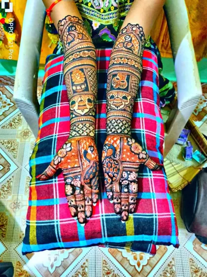 A vibrant photo of a full bridal design, showcasing the rich henna stain against a colorful background.