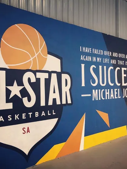 An angled view of our All-Star Basketball mural. We've created an environment that feels authentic and inspiring for every basketball fan.