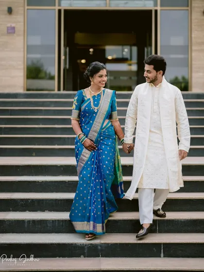 The couple descending a grand staircase, a cinematic shot from their engagement day.