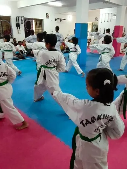 A view from the back, showing the Taekwondo logo on their doboks.