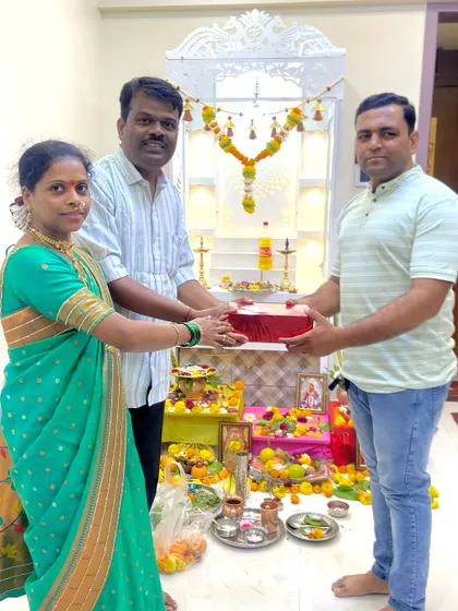 A happy moment with the Bhosle family during their Griha Pravesh puja. Their beautiful new mandir can be seen in the background, all set for the ceremony.