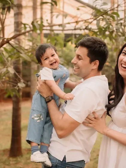 A candid shot full of laughter as the family plays together during their outdoor session.