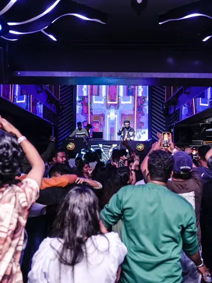 A view from the back of the club shows a dance floor full of people with their hands up. I love seeing the entire room engaged and vibing together.