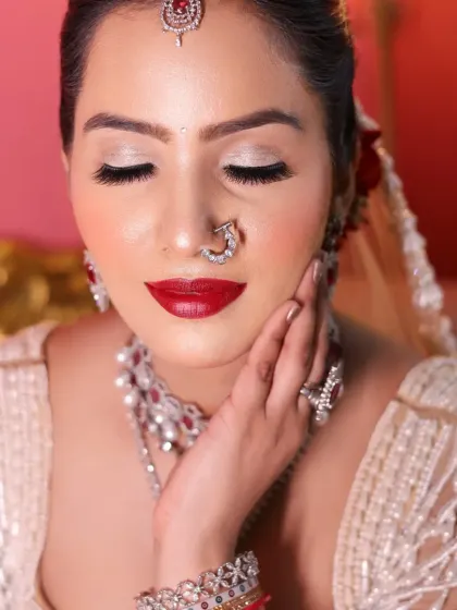 A soft, romantic pose showcasing the beautiful red lip and glowing skin.