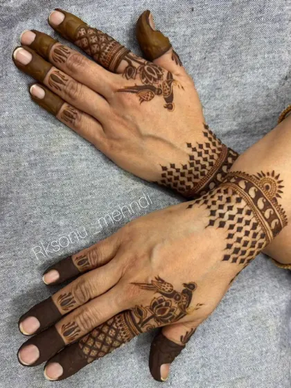 An elegant and modern design for Eid celebrations. It features a crescent moon motif combined with delicate floral patterns and geometric checkerboard designs on the back of the hands.