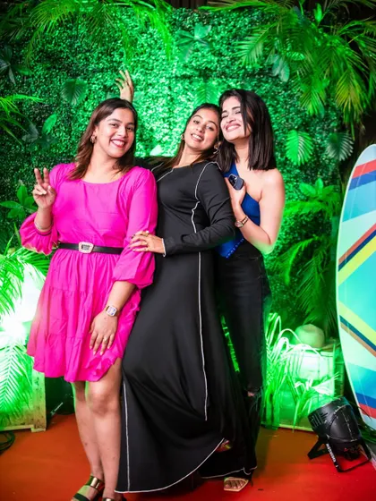 Friends having a great time and posing by the surfboard prop at Roxy. It's all about the fun details.