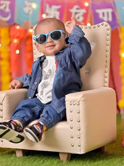 A cool little dude in sunglasses poses in a chair during his Diwali shoot. I love capturing the fun and unique personality of every child.