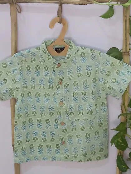 The Tropical Shirt, featuring a lovely pineapple print, is perfect for that beach vacation you're planning. It's made of soft cotton and is available in a wide range of sizes.