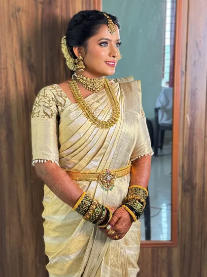A full-length shot showing how the makeup, hair, and saree come together. The entire look is cohesive and stunning, a true testament to professional artistry.