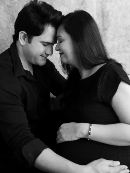 An intimate black and white close-up. This pose, with foreheads touching, creates a powerful sense of connection and quiet anticipation.