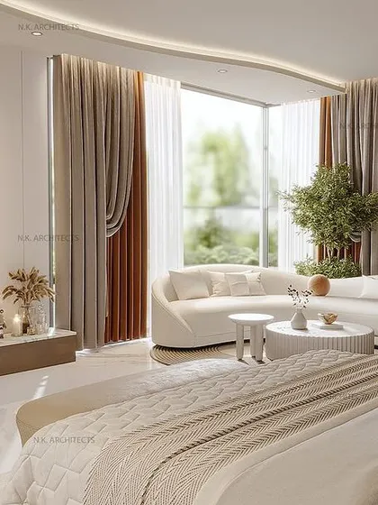 This bedroom is a haven of comfort and glamour. We designed a large, open space with a dedicated seating area by the window, a clean TV wall, and a neutral color palette to create a world of refinement and style.