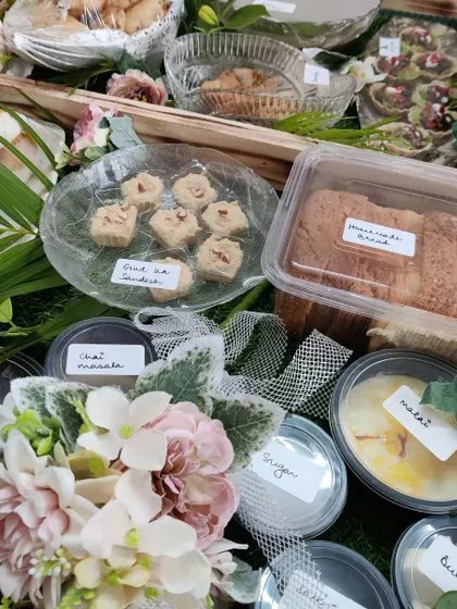 A close-up of our breakfast hamper contents, showing individual portions of Malai, butter, sugar, and our homemade 'Gud ka Sandesh' and Marmalade Bread.