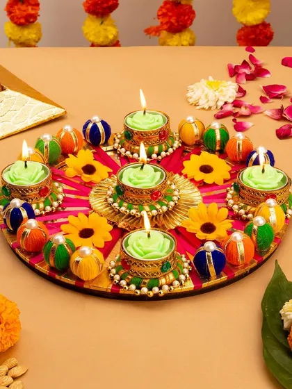 A beautifully arranged Diwali thali with decorative candles from Gopal Shoppe. This festive shot is perfect for seasonal marketing, evoking tradition and celebration.