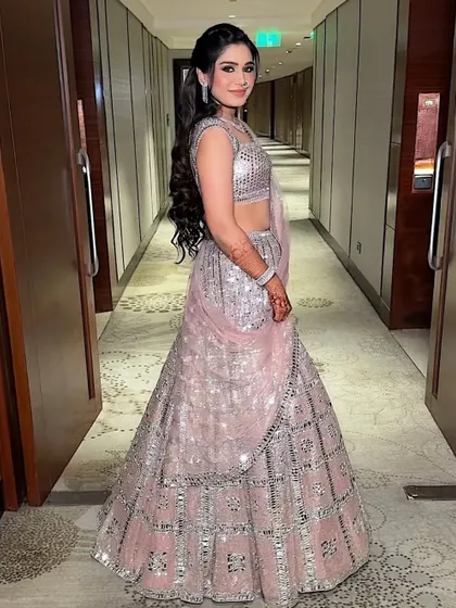 A full-length shot of this stunning mirror-work lehenga. The makeup is glamorous yet elegant, a perfect match for the dazzling outfit.