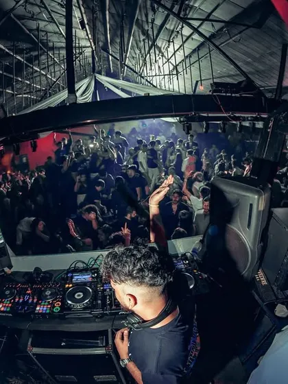 A fisheye view from the DJ booth, capturing the entire club in one frame. This perspective shows the scale of the party and my central role in it.