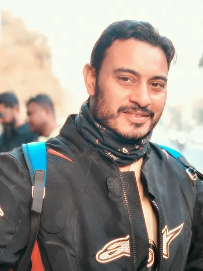 A friendly portrait of a rider looking directly at the camera. The focus is on his approachable expression, highlighting the personal connections made at these events.
