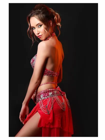 A profile shot from the belly dancing costume shoot. The backlighting adds a beautiful glow and highlights the model's silhouette and the costume's design.