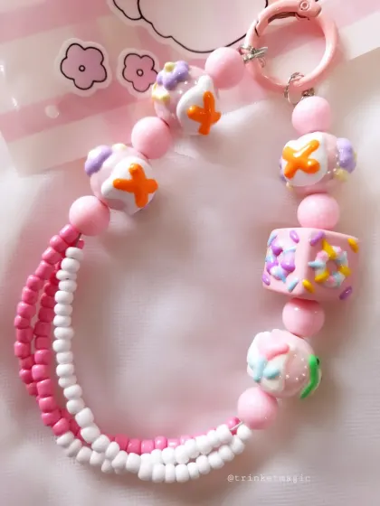 Another angle of the pink cake-bead charm, showing the different textures and shapes of the beads I use to create these unique pieces.