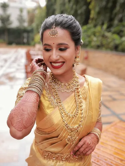 A joyful, candid moment. This image shows how the makeup enhances her smile, creating a look that is both beautiful and full of life.