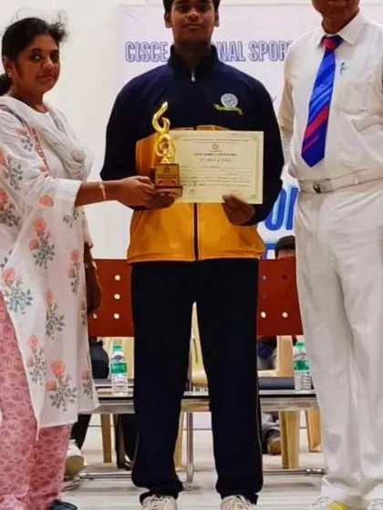 A student receiving his trophy and certificate at a CISCE National Sports event. We prepare athletes for success in major school and university competitions.