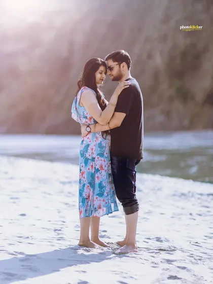 A romantic close-up of a couple on a beach in Rishikesh, with the soft backlighting creating a beautiful halo effect.