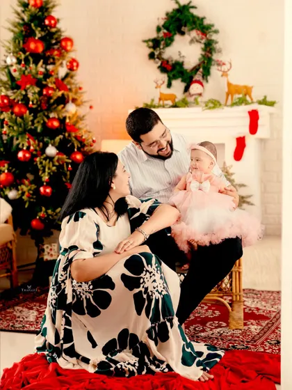 A heartwarming family portrait from a Christmas-themed shoot. The love and joy of the season are perfectly captured in their happy expressions.